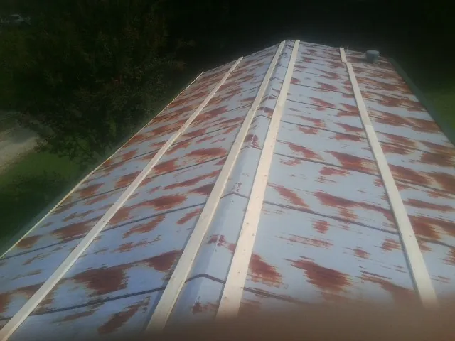 Rusted metal roof panels with new wood purlins before replacement — Storm Damage Roof Repair in La Center by Roofing Brothers